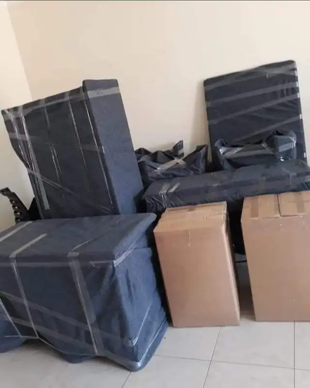 Villa movers Dubai crew securing furniture inside a moving truck